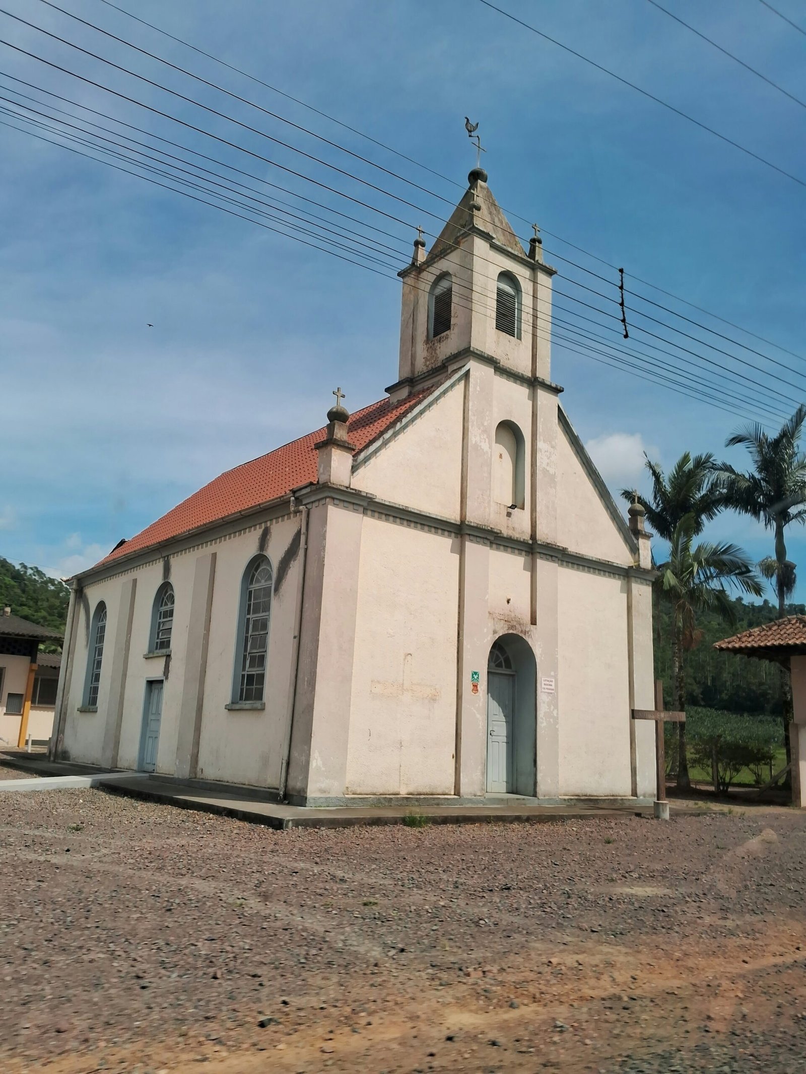 an old church with a red roof and a blue door